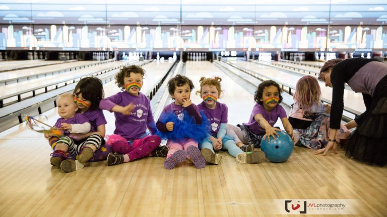 Kids sitting on bowling lane in Bowl-a-thon 
